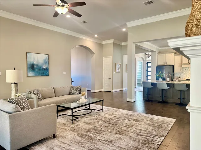 a living room with furniture and a chandelier