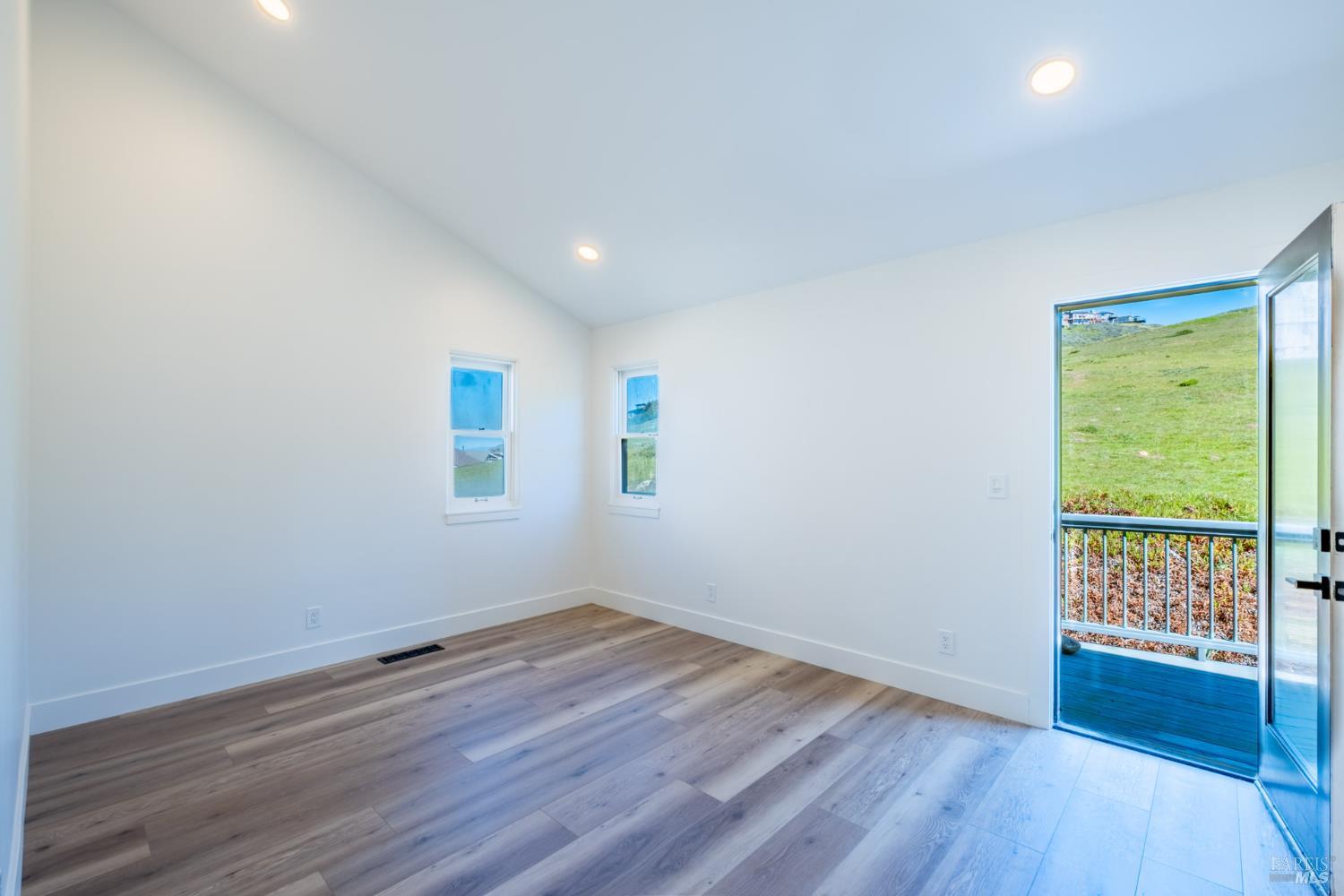 32 Kailua Way Dillon Beach, CA 94929 - Photo 15 of 19 a view of an empty room with wooden floor and a window