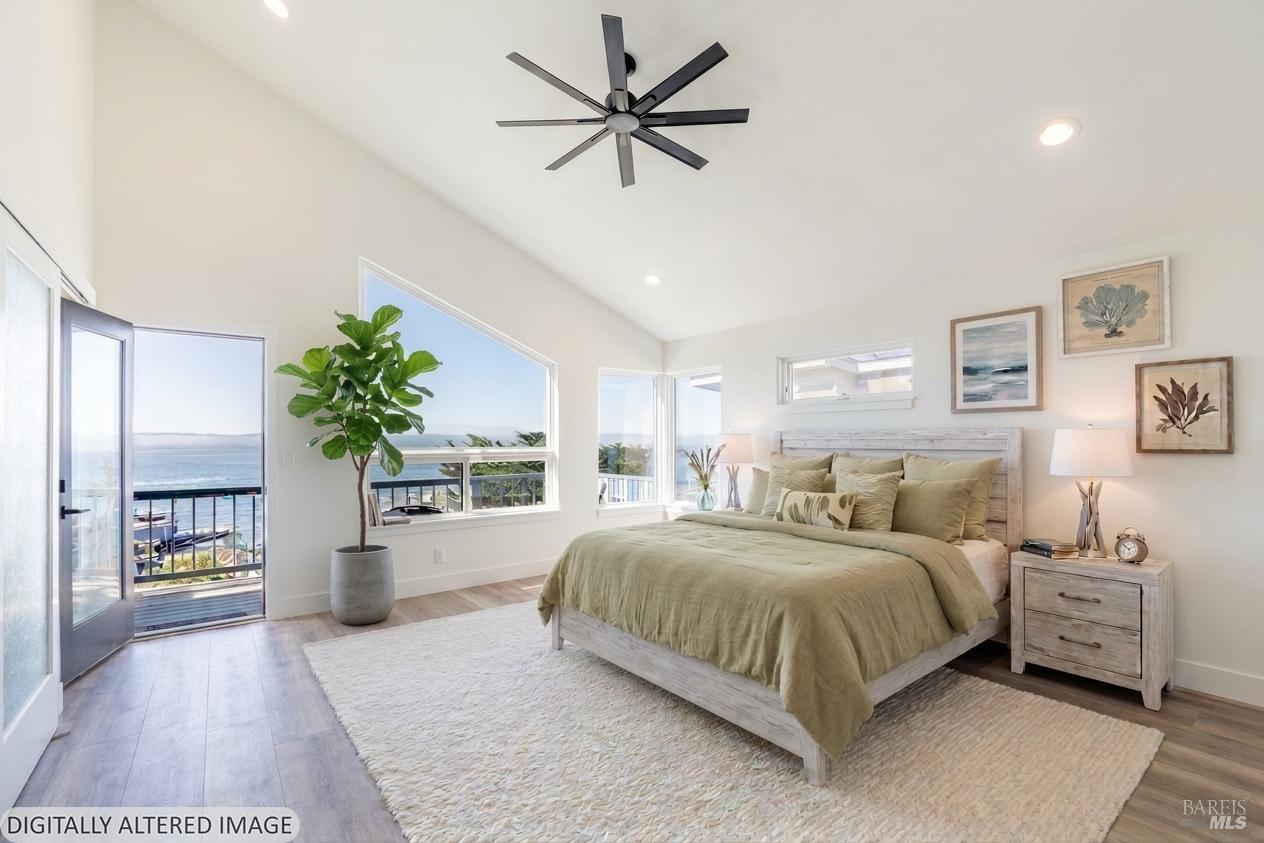 32 Kailua Way Dillon Beach, CA 94929 - Photo 6 of 19 a bedroom with a large bed and a chandelier