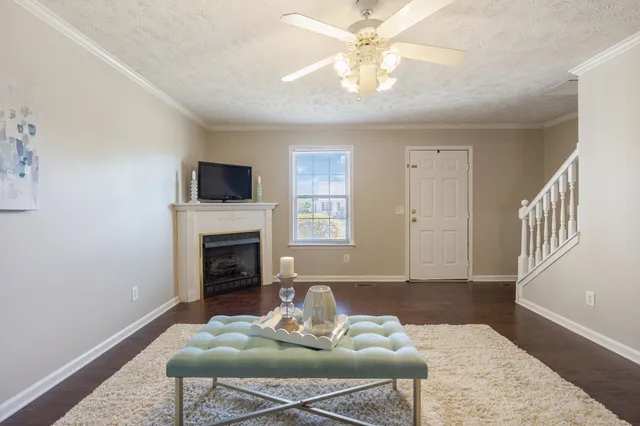 a living room with furniture a fireplace and a flat screen tv