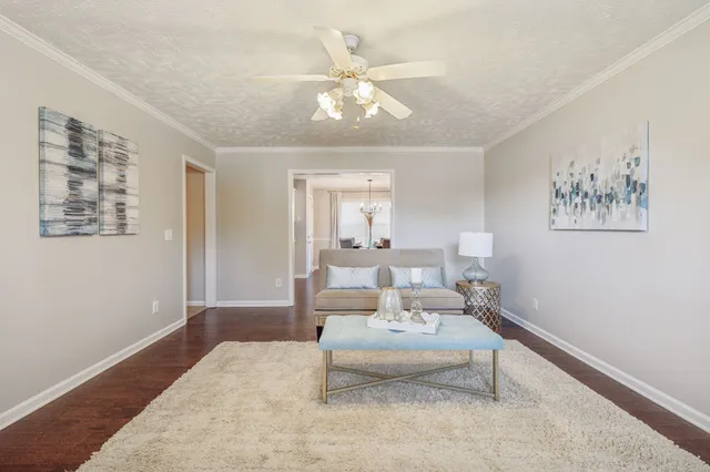 a living room with furniture and white walls