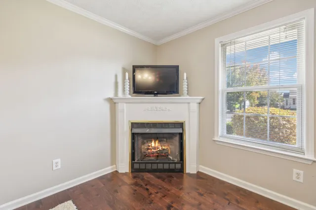 a living room with a fireplace and a window
