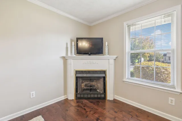 a living room with a fireplace and a flat screen tv
