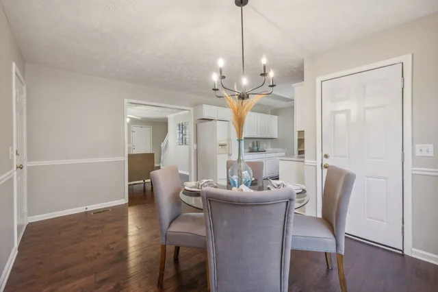 a view of a dining room with furniture wooden floor and chandelier