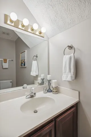 an empty room with fan and entrance