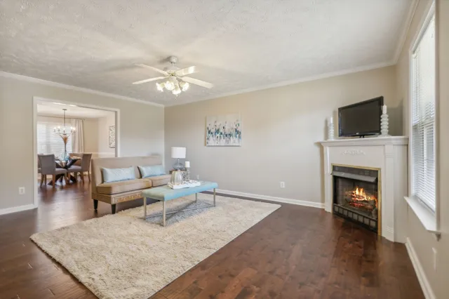 a living room with furniture a fireplace and a flat screen tv