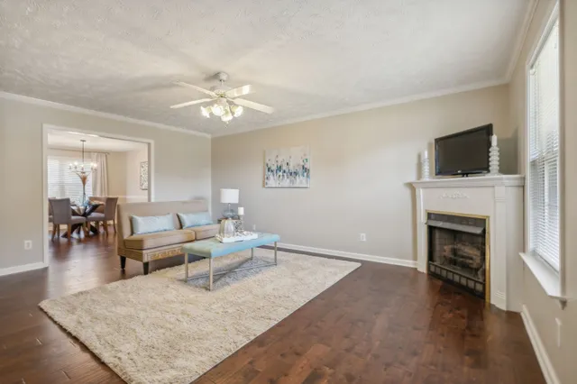 a living room with furniture a fireplace and a flat screen tv