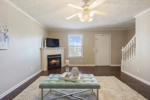 a living room with furniture a fireplace and a flat screen tv