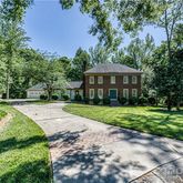 a view of a house with potted plants
