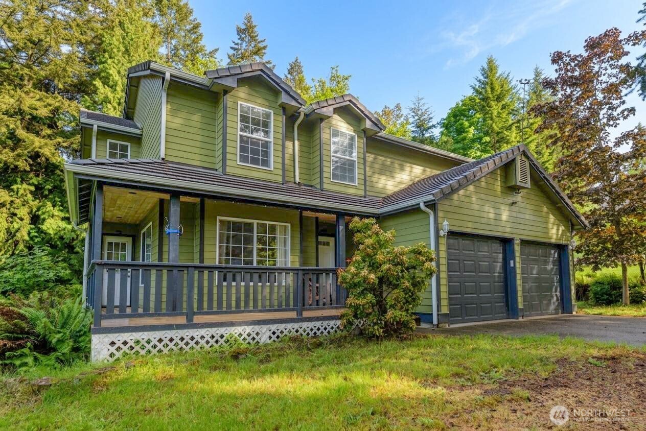 301 Mt Pleasant Estates Road Port Angeles, WA 98362 - Photo 1 of 40 a view of a house with a small yard and wooden fence