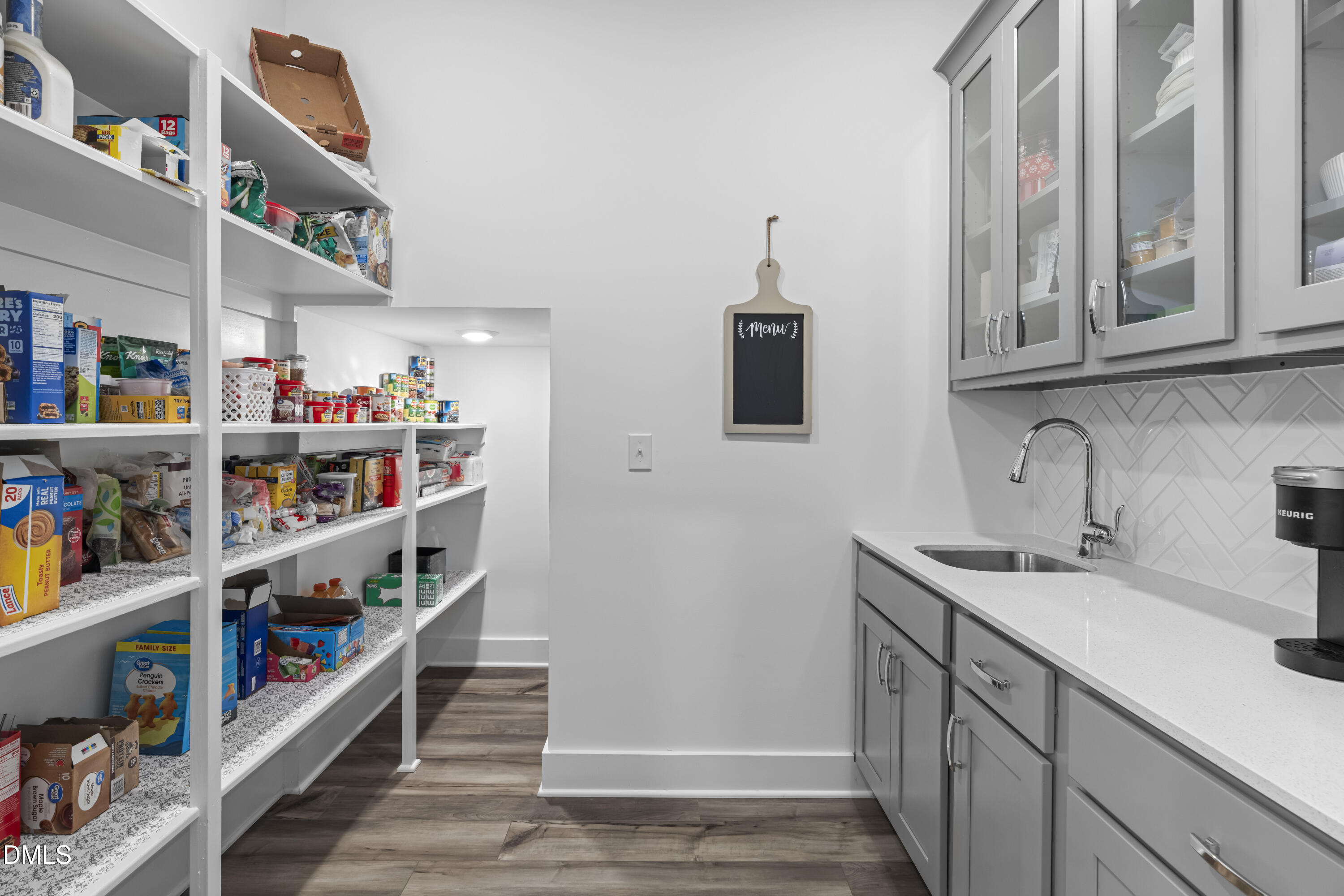 108 Bridge Street Smithfield, NC 27577 - Photo 13 of 48 a kitchen with lots of clutter and cabinets