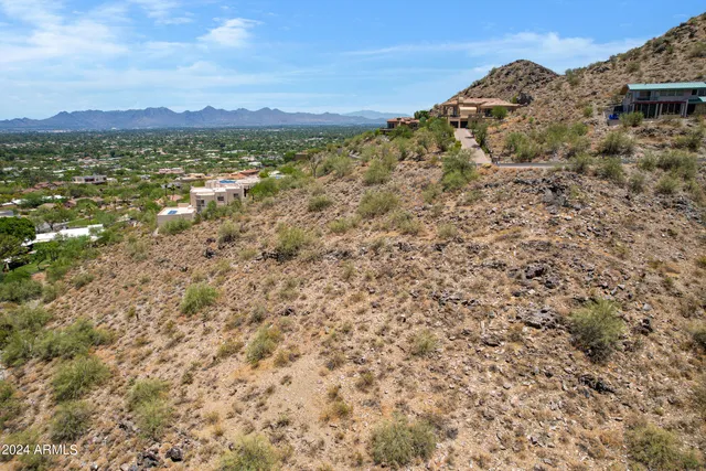 a view of a large building with mountains in the background