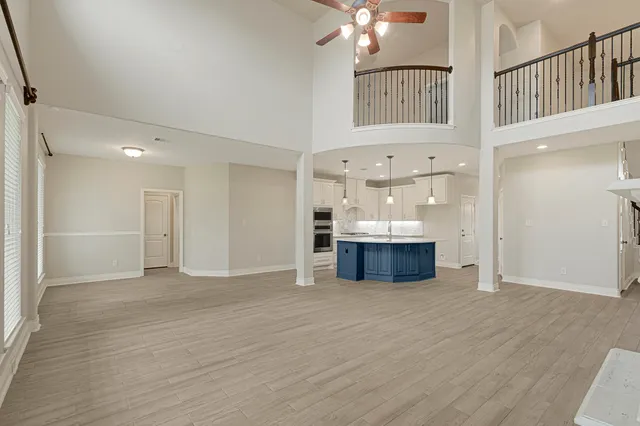 a view of kitchen with sink and refrigerator