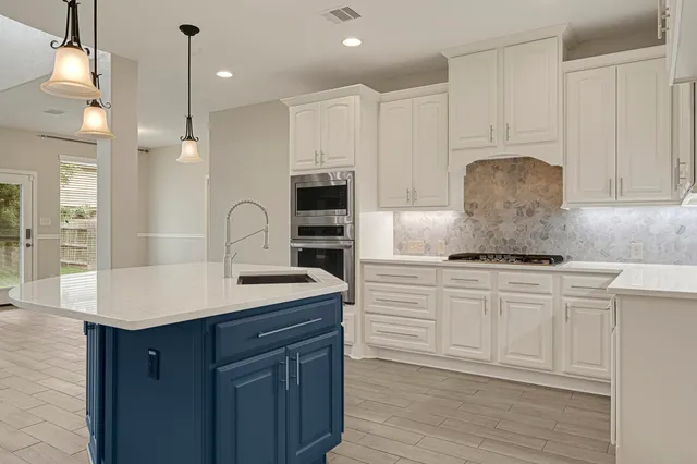 a kitchen with a sink and cabinets