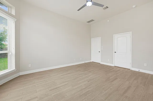 a spacious bathroom with a granite countertop tub sink and mirror