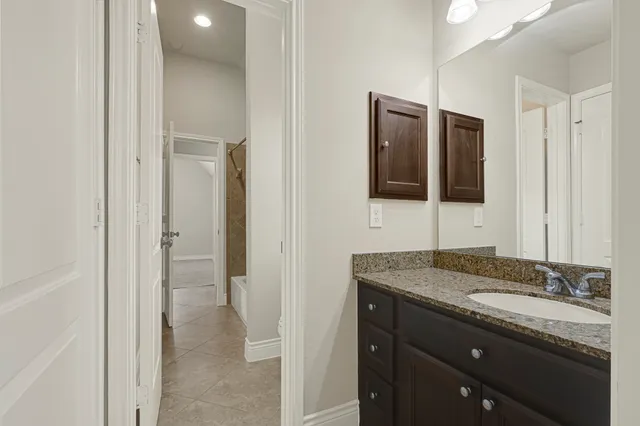an empty room with chandelier fan