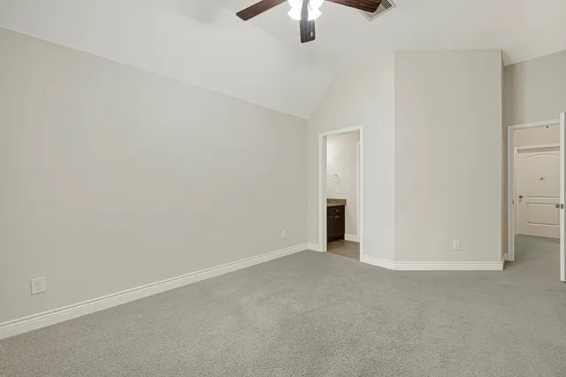 a front view of a house with a garden and yard