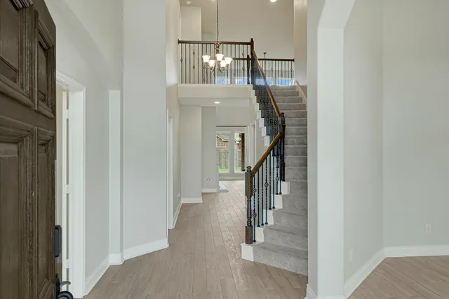 a view of entryway and hall with wooden floor