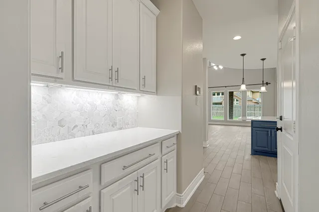 a view of a hallway with wooden floor and entryway