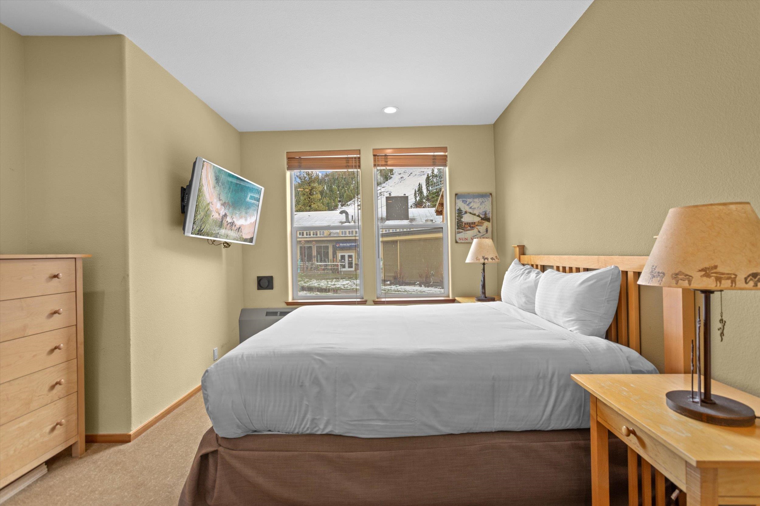 201 Shirley Cyn Road, Unit 714 Olympic Valley, CA 96146 - Photo 7 of 27 a bedroom with a bed and a flat tv screen on dresser