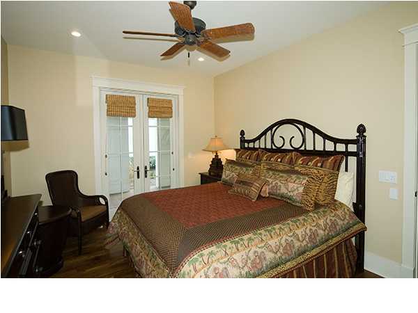 282 Blue Mountain Road Santa Rosa Beach, FL 32459 - Photo 13 of 16 a bedroom with a bed and a chandelier