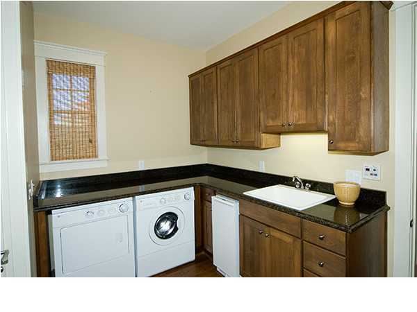 282 Blue Mountain Road Santa Rosa Beach, FL 32459 - Photo 14 of 16 a kitchen with a sink a stove a microwave and cabinets