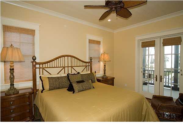 282 Blue Mountain Road Santa Rosa Beach, FL 32459 - Photo 10 of 16 a bedroom with a bed a lamp and a large window