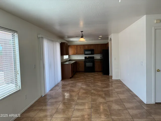 a large kitchen with cabinets and stainless steel appliances