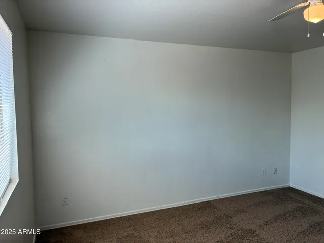 an empty room with closet and a bathroom