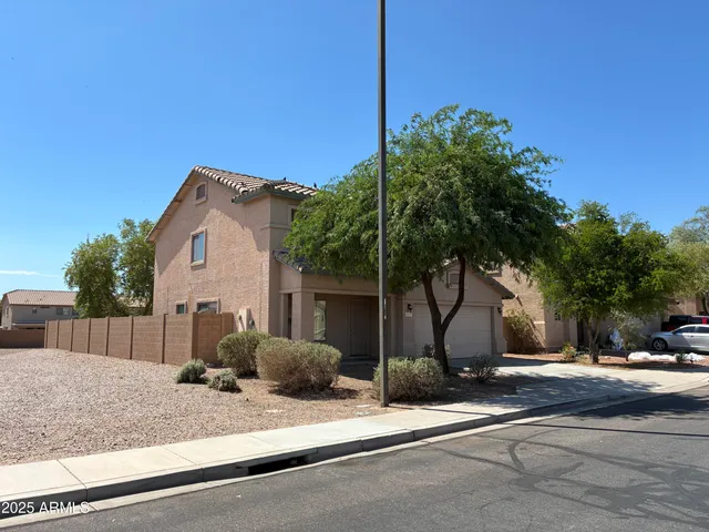 a view of a house with a yard and garage