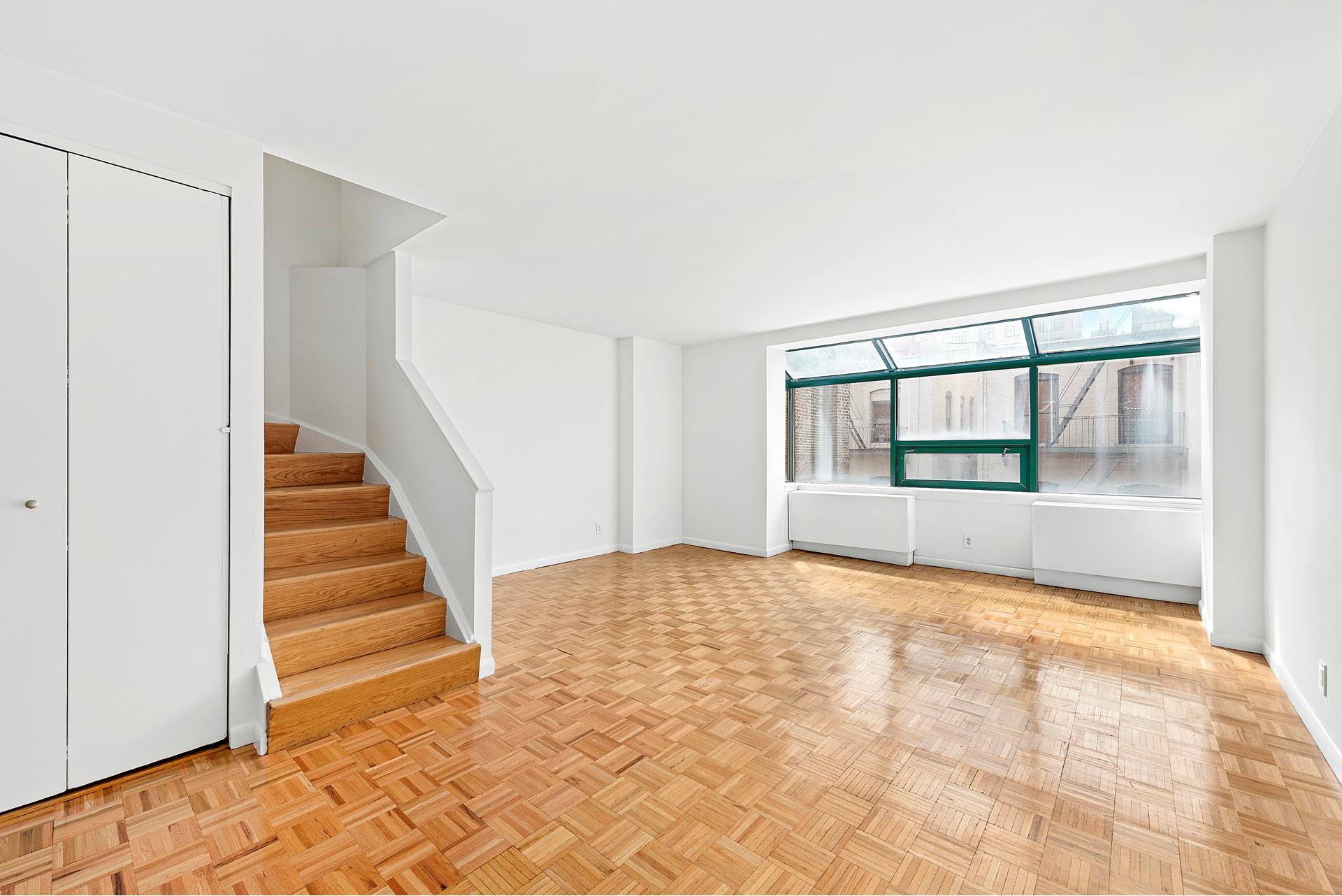 a view of an empty room with stairs