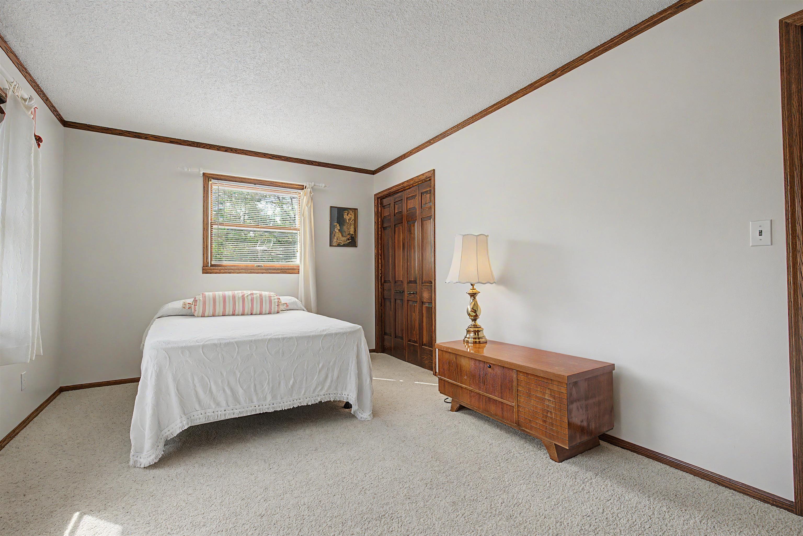 17380 Corbett Road Mount Carroll, IL 61053 - Photo 15 of 65 a bedroom with a bed and a window