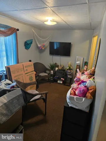 a bedroom with furniture and a flat screen tv
