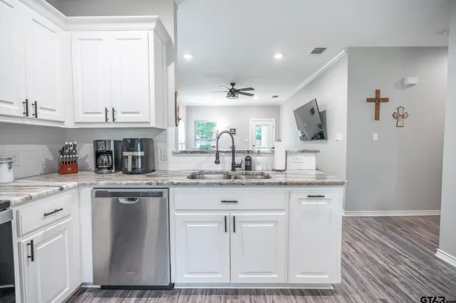 a kitchen with cabinets and window