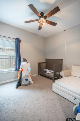 a bedroom with furniture and a chandelier