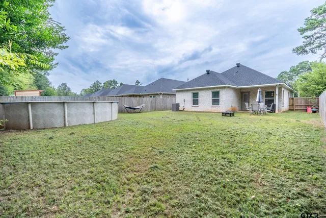 a view of a house with a yard and sitting area