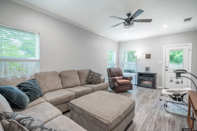 a living room with furniture and a fireplace