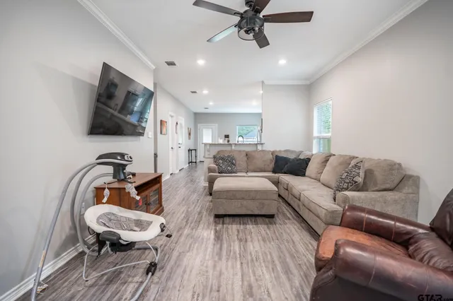 a living room with furniture and a flat screen tv