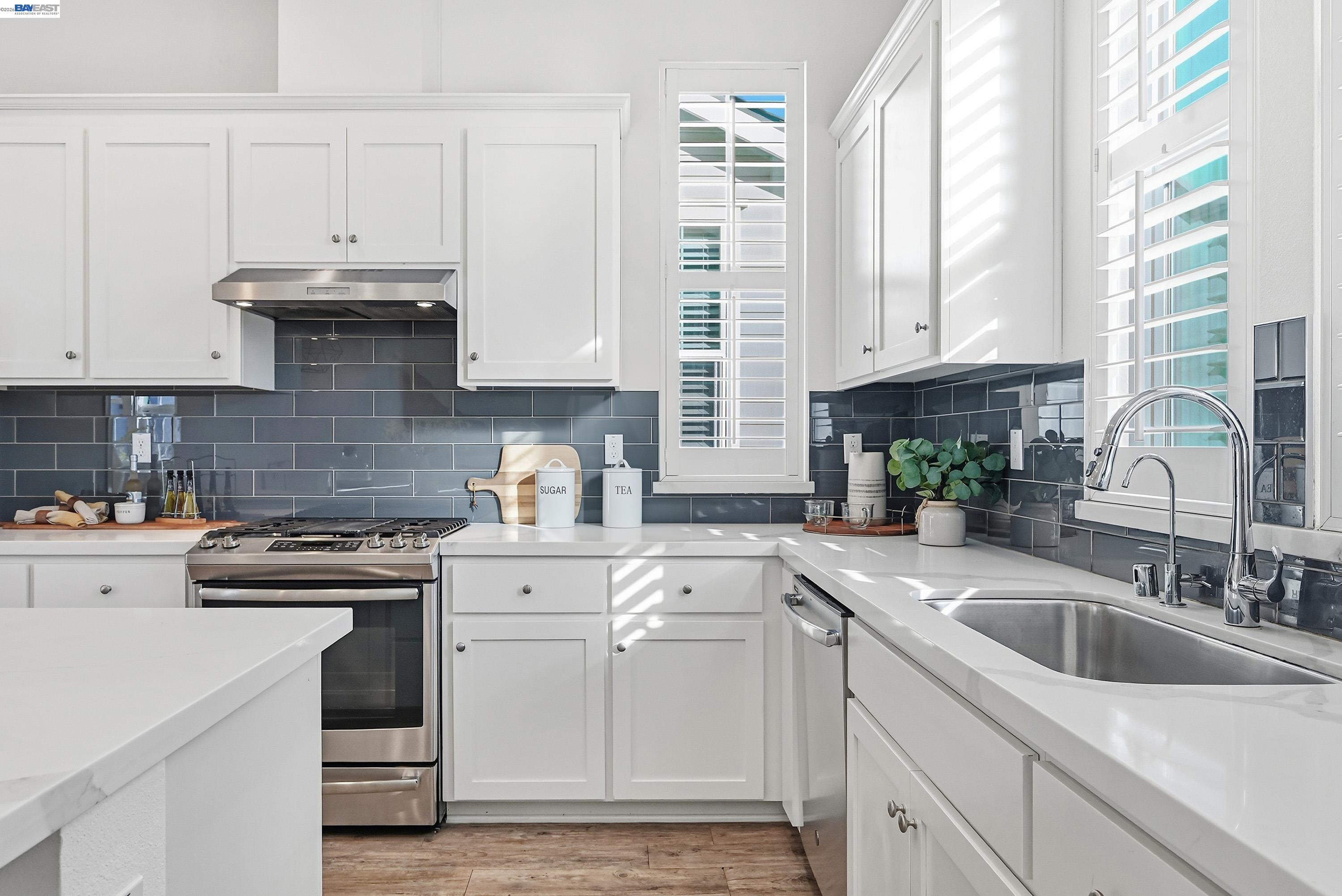 37541 Bay Crest Road Newark, CA 94560 - Photo 11 of 50 a kitchen with granite countertop white cabinets and white appliances