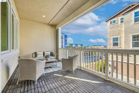 a view of a balcony with wooden floor and furniture