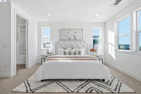 a bedroom with a large bed and a window