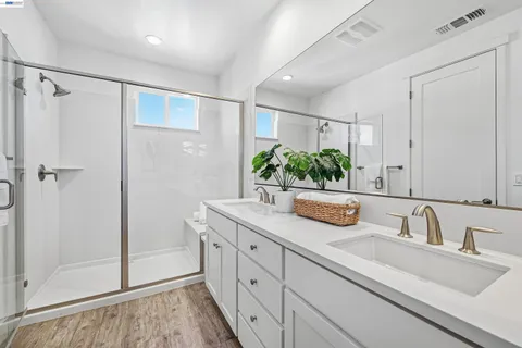 a bathroom with a shower sink and mirror