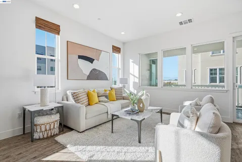 a living room with furniture and a painting on the wall