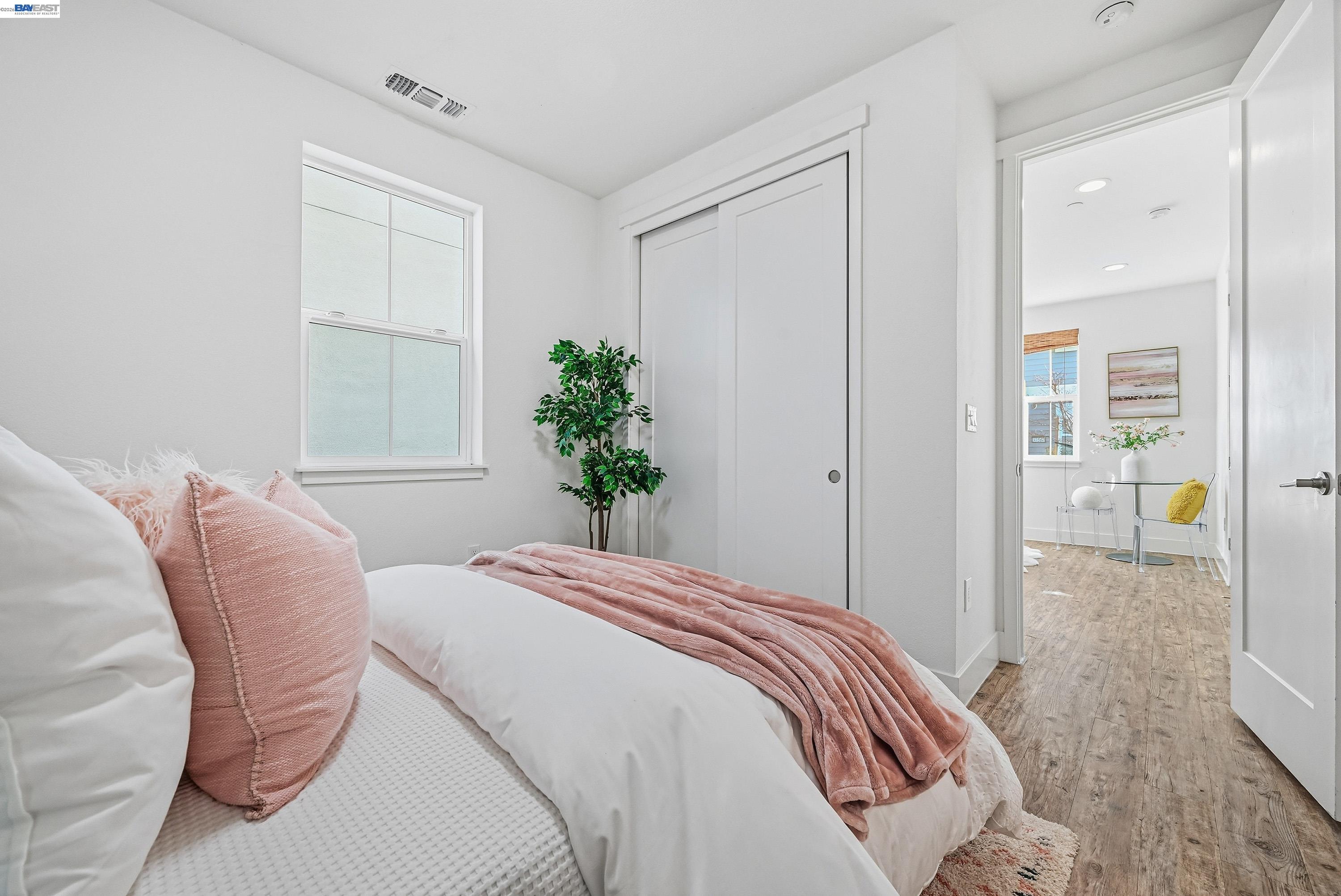 37541 Bay Crest Road Newark, CA 94560 - Photo 26 of 50 a bedroom with a bed and a potted plant