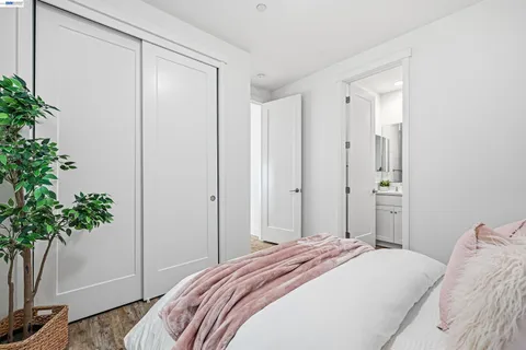 a bedroom with bed and paintings on the wall