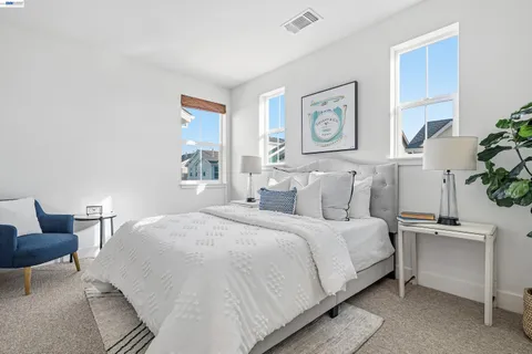 a bedroom with a bed and a chair