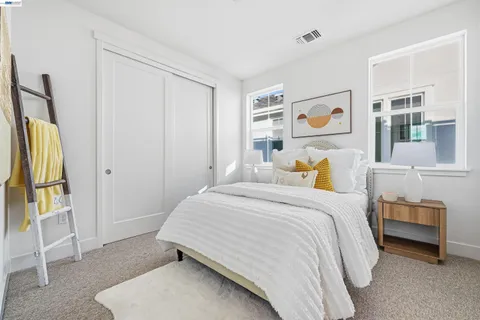 a view of a kitchen with white cabinets