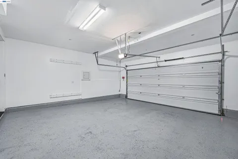 a view of a patio with couches table and chairs under an umbrella