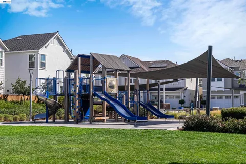a view of backyard with swimming pool and outdoor seating