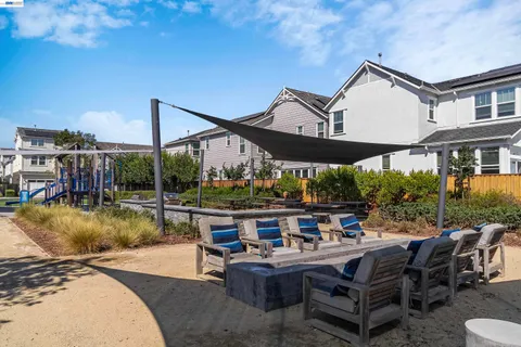 a backyard of a house with outdoor seating
